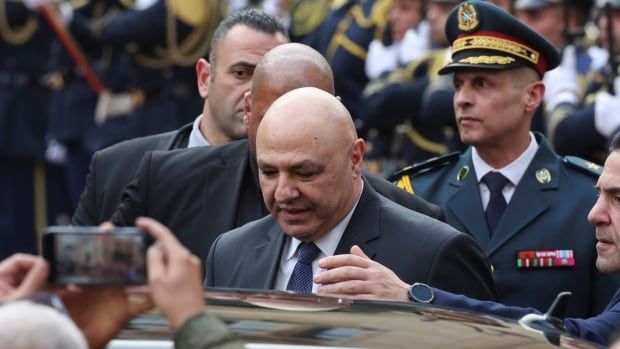 Lebanon's elected president Joseph Aoun gets into a vehicle among a crowd of people.