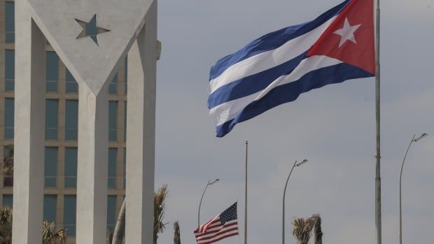 Cuban and American flags flap in the wind outside the U.S. Embassy in Havana.