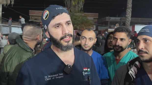 Dr. Muhammad al-Tahir and a crowd of men gather to celebrate the news of a ceasefire between Israel and Hamas.