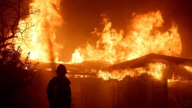 A firefighter at the scene of a large fire in Pasadena, Calif.