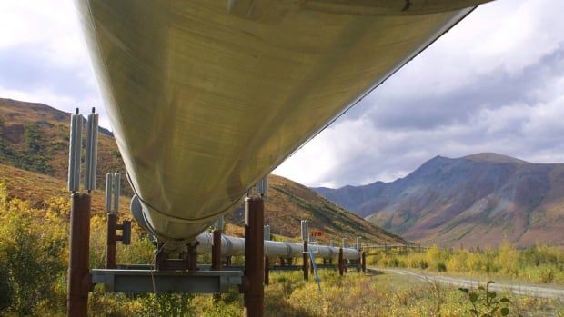 The view from under a large pipeline in a mountainous area.