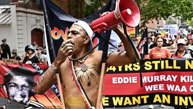 A protester chants on a megaphone. 