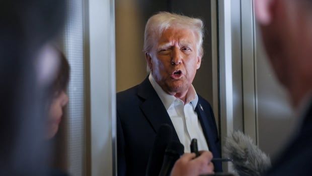 U.S. President Donald Trump speaks with reporters as they ask questions aboard Air Force One during a flight from Las Vegas, Nevada, to Miami, Florida, U.S., January 25, 2025. 