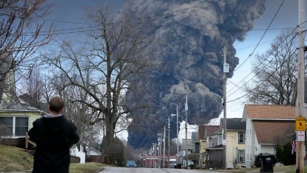 A dark grey plume of toxic smoke billows over Palestine, Ohio after a train derailed on Feb. 3, 2023.