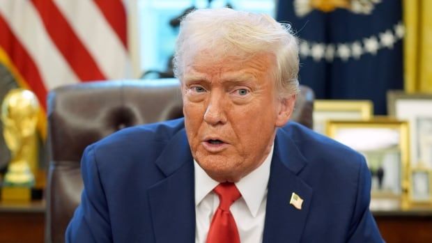 U.S. President Donald Trump sitting at his desk in the Oval Office at the White House.