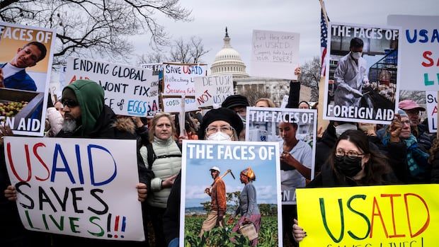 People holding up protest signs