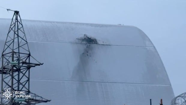 A damaged section of a white roof of a structure is shown outdoors.