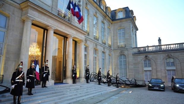 Republican Guards stand outside the Elysee Palace during an informal meeting of leaders from key European Union nations and the United Kingdom in Paris on Monday.