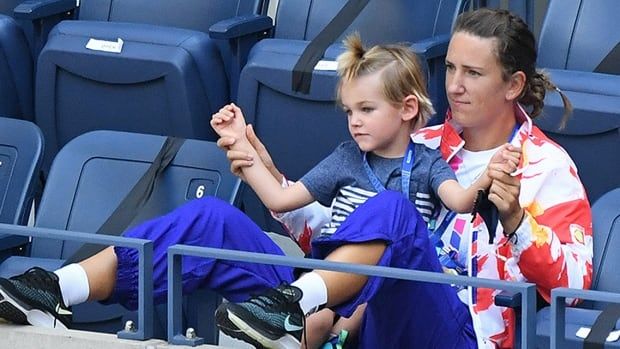 Belarusian tennis player Victoria Azarenka sits with her son Leon in her player's suite at the U.S. Open at USTA Billie Jean King National Tennis Center in New York on September 4, 2020 