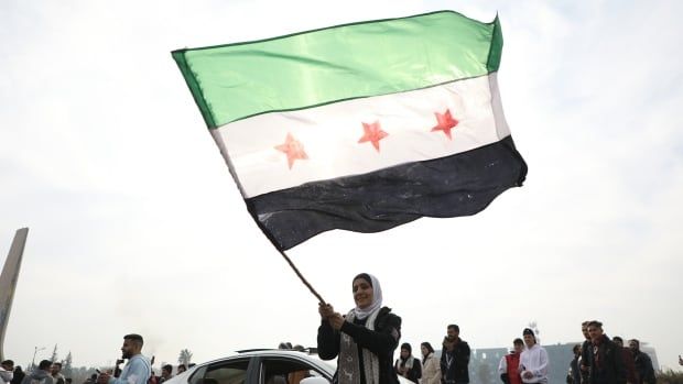 A woman waves a flag