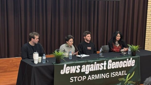 four people sit a table with a green table cloth