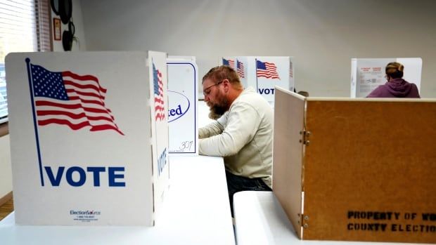 A male voter fills out his ballot.