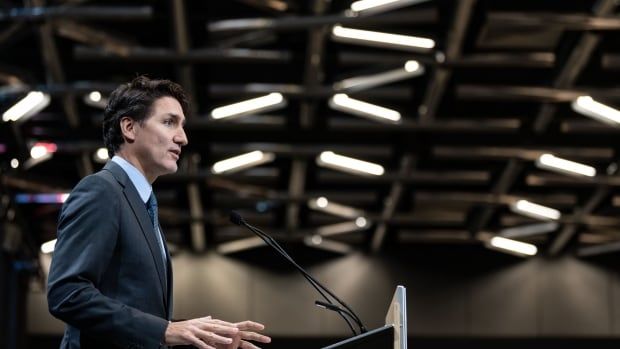 Prime Minister Justin Trudeau stands at a podium in a Montreal conference hall.