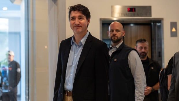 Prime Minister Justin Trudeau walks through the lobby of the Delta Hotel by Marriott, Saturday, Nov. 30, 2024, in West Palm Beach, Fla.