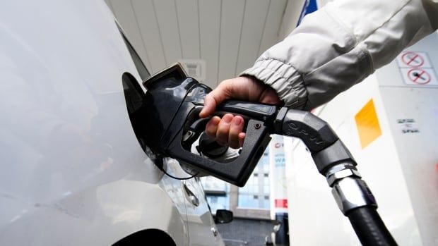 A person places a gas pump in their car.