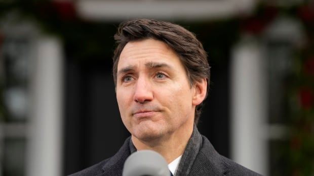 A close up image of Prime Minister Justin Trudeau speaking at a podium staged outside Rideau Cottage in Ottawa.