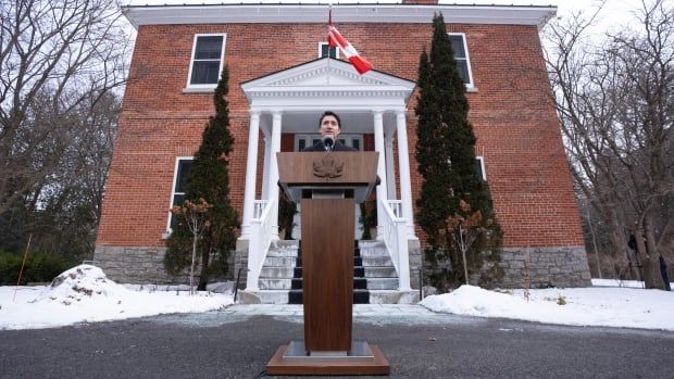 Justin Trudeau at podium outdoors in front of Rideau Cottage