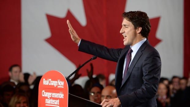 A man stands and waves at a podium