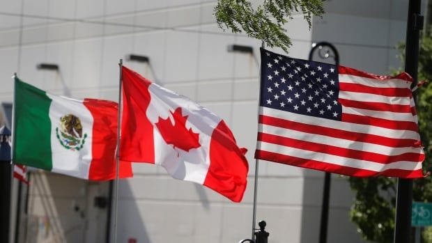 Flags of the U.S., Canada and Mexico fly next to each other.