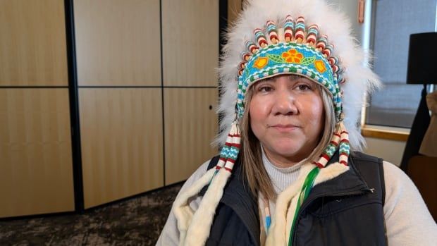 A woman in an Indigenous chief's headdress