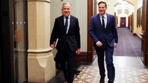 Liberal Leader Mark Carney, left, arrives to the West Block of Parliament Hill in Ottawa on Monday, March 10, 2025 with Liberal MP Marco Mendicino.