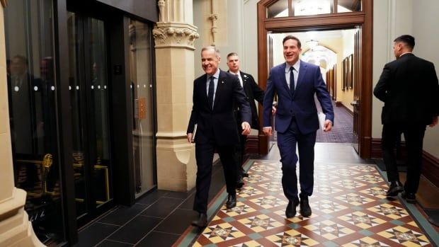 Liberal Leader Mark Carney, left, arrives to the West Block of Parliament Hill in Ottawa on Monday, March 10, 2025 with Liberal member of Parliament Marco Mendicino.