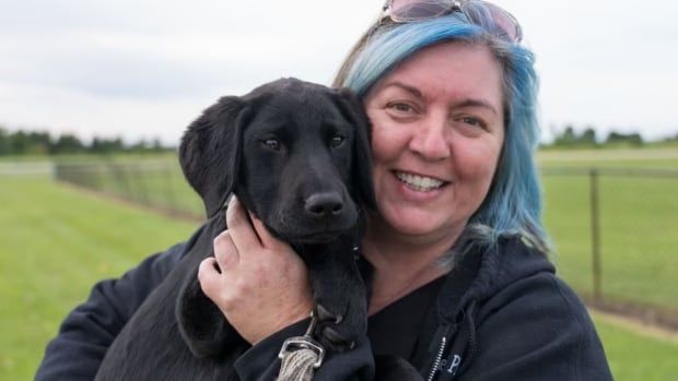 Denise Angus, founder of Toronto pet rescue shelter Mattie’s Place, holds Woody, a puppy that was up for adoption. 