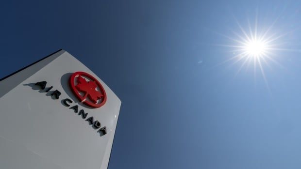 The Air Canada logo is visible at the top of a white structure of some sort, seen from an upwards angle that shows mostly the blue sky beyond the white structure. 