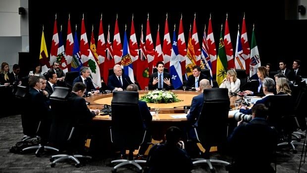 People are seen seated at a roundtable.