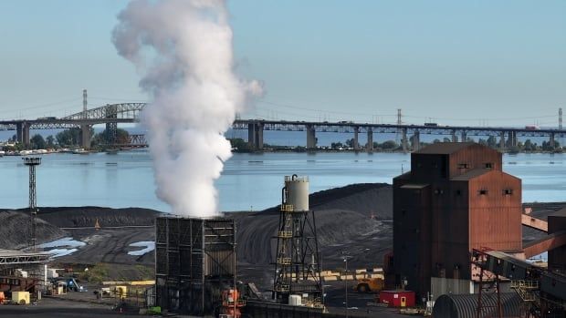 A plume of smoke or steam rises from an steel production facility in Hamilton, Ontario.