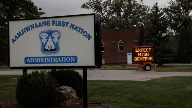 A sign warns of a possible benzene leak at the Aamjiwnaang First Nation, near Sarnia, Ont., on Oct. 1, 2024. The removal of the substance from the nearby Ineos Styrolution plant prompted a voluntary evacuation order in the community. 