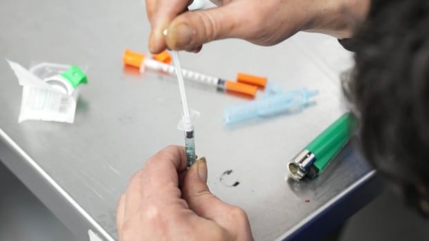 A client draws up fentanyl as he visits the consumption room at Moss Park Consumption and Treatment Service, in Toronto on Dec. 3, 2024.