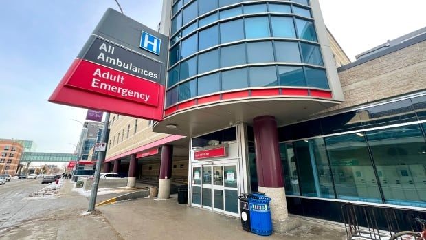 The exterior of a hospital is shown with a sign reading "All ambulances" and "Adult emergency."