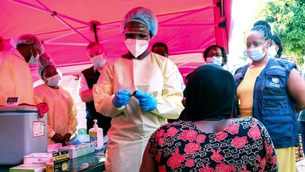 A health worker prepares to administer a vial of a vaccine against the Sudan strain of Ebola, during a clinical trial in Kampala, Uganda. 