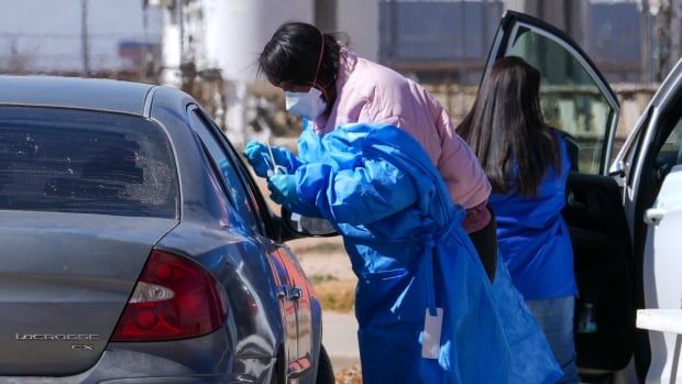 A health worker administers a measles test to a car passenger at a mobile testing site in Texas in February 2025. 