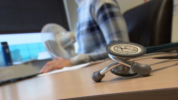 Close up of stethoscope resting on doctor's office desk.