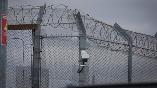 Barbed wire fencing with a security camera