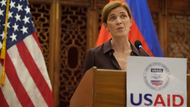 A woman speaks at a podium.