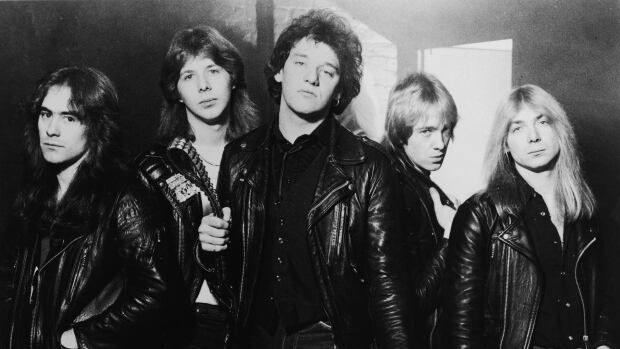 Five people wearing leather jackets pose in a black and white image.