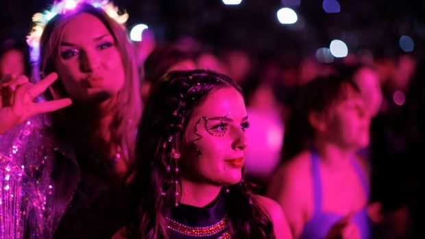 Closeup of fans listening to Gracie Abrams, who opens for Taylor Swift's Eras Tour at Rogers Centre.