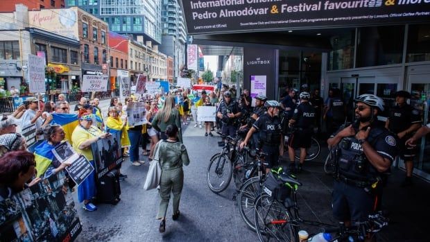 Protestors are photographed outside of the TIFF Lightbox theatre in Toronto during a screening of the documentary film Russians at War on Sept. 17, 2024. The documentary played at the Toronto International Film Festival (TIFF) Lightbox on Tuesday, after the festival suspended showings earlier this week due to security concerns. The documentary spurred protests from Ukrainian officials and community groups who say the film amounts to propaganda.