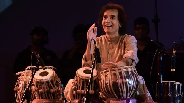 A man is pictured drumming. 