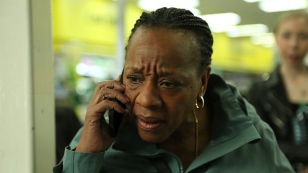 An angry woman speaks into a cell phone.