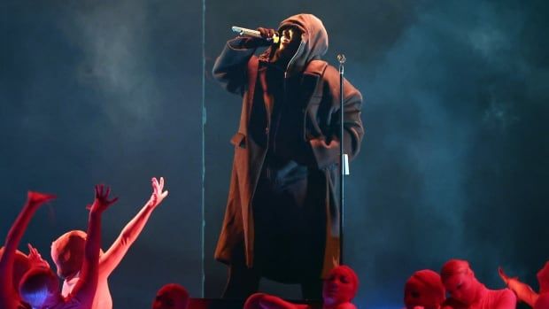 The Weeknd, wearing a hooded cloak, performs onstage during the 67th Grammy Awards on Feb. 2, 2025, in Los Angeles.