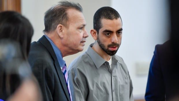 Hadi Matar, right, charged with severely injuring author Salman Rushdie in a 2022 knife attack, stands next to public defender Nathaniel Barone in Chautauqua County court in Mayville.