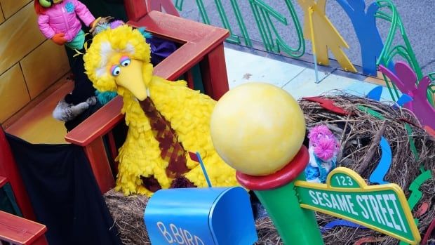 Big Bird sits in a Sesame Street float.