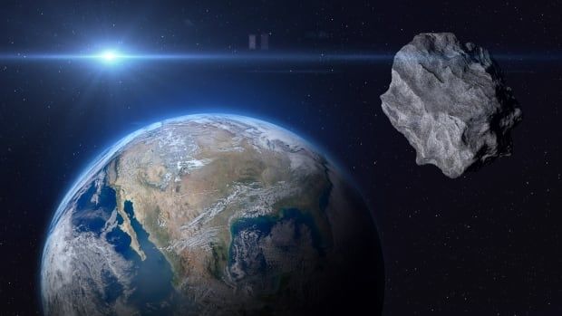 A large rock is seen in space with Earth in the background.