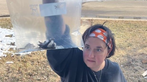 Person holding a bat in a ziplock bag.