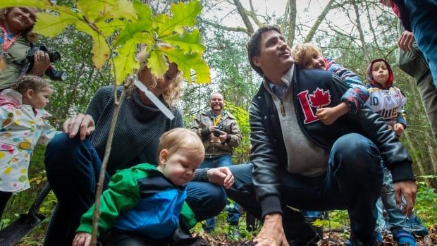 Federal Liberal leader Justin Trudeau shares a moment while he plants a tree with his son Hadrien (right) at the Frank Conservation Area in Plainfield, Ont. on Sunday, October 6, 2019. THE CANADIAN PRESS/Frank Gunn