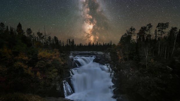 Photo of Milky Way core in night sky over water fall